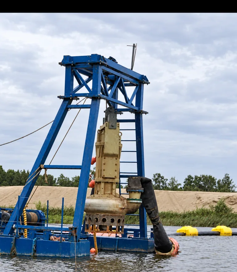 AI-enhanced company-supplied photo: Submersible pump suspended from a blue A-frame on a floating pontoon, with its discharge hose