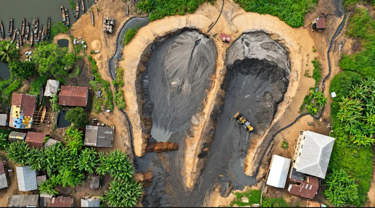 AI-enhanced company-supplied photo: Company-supplied aerial view of sand stockpiles, a loader and surrounding access tracks